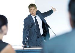 Speaker in front of microphones