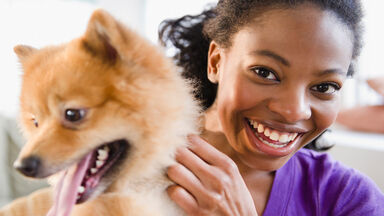girl smiling with her dog