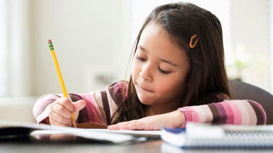 girl working on plural noun worksheet